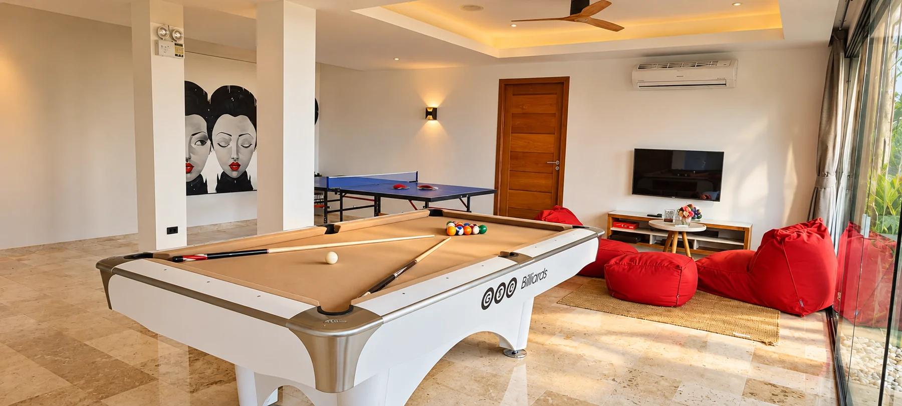 Aruna's real games room with its blue table-tennis table and pool table, with staged lighting